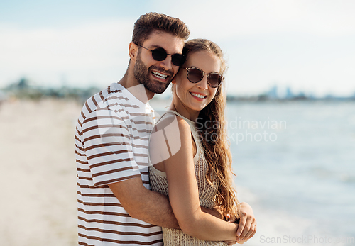 Image of happy couple on summer beach