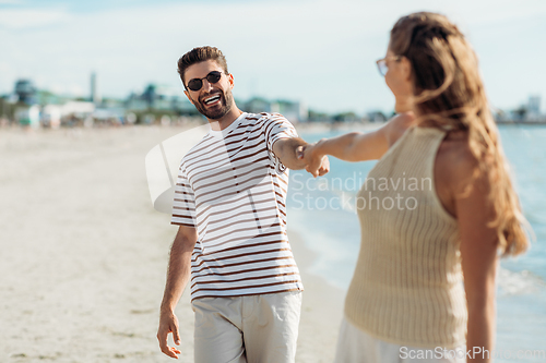 Image of happy couple on summer beach