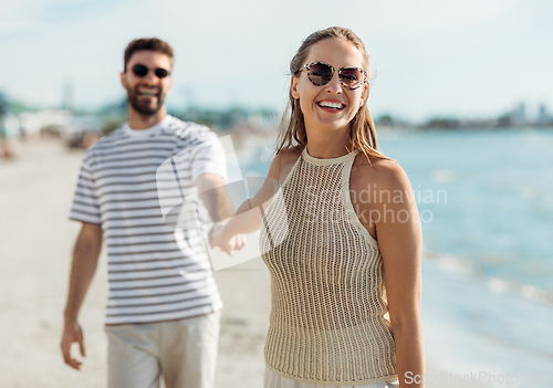 Image of happy couple on summer beach