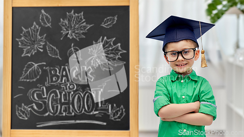 Image of little student boy in bachelor hat or mortarboard