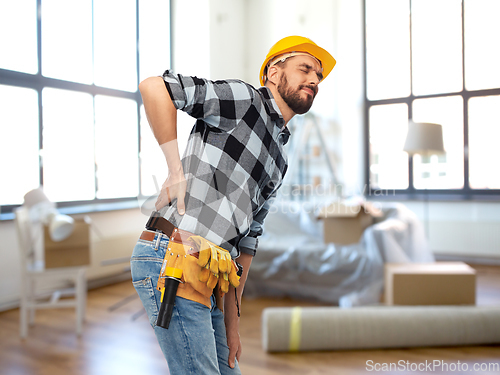 Image of male worker or builder having back ache at home