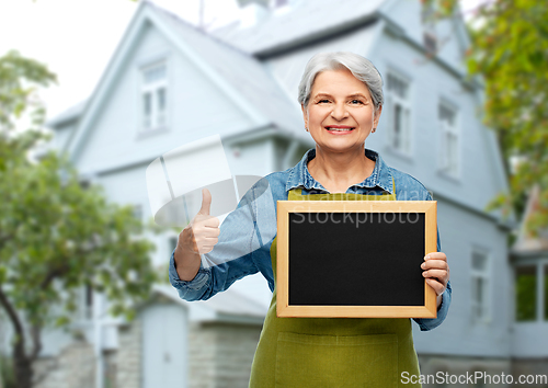 Image of senior gardener with chalkboard showing thumbs up