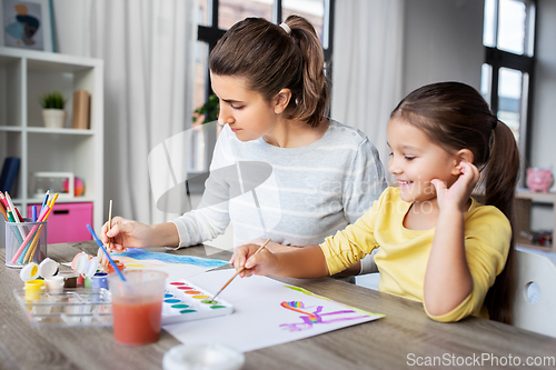 Image of mother with little daughter drawing at home