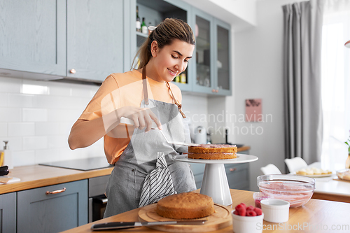 Image of woman cooking food and baking on kitchen at home