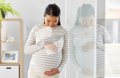 Image of happy pregnant asian woman at home