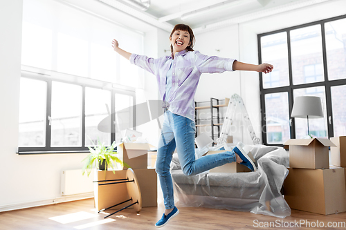 Image of happy asian woman with stuff moving to new home