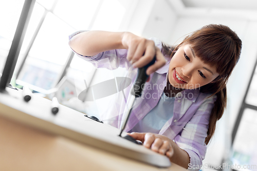 Image of happy woman assembling coffee table at new home