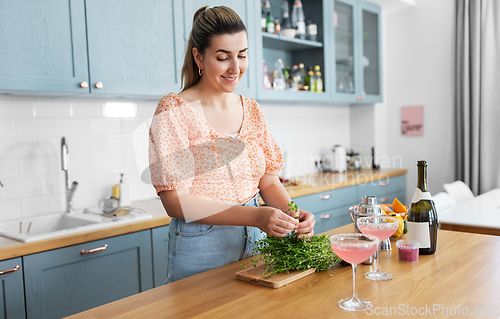 Image of woman making cocktail drinks at home kitchen