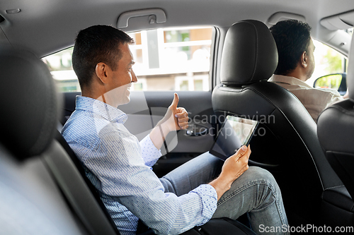 Image of man with tablet pc having video call in taxi car