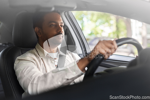 Image of indian man or driver driving car