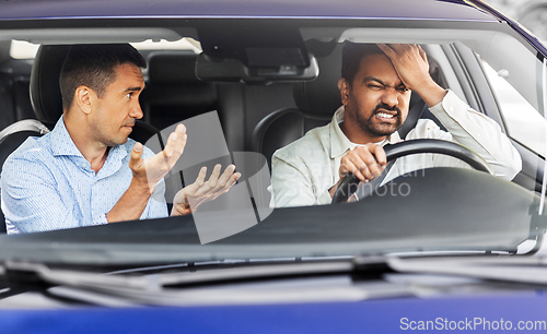 Image of car driving instructor talking to man failed exam