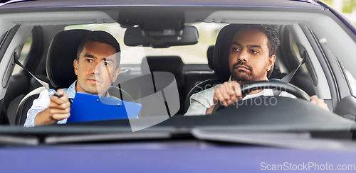 Image of car driving school instructor and young driver