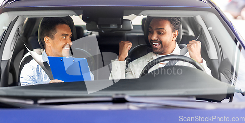 Image of smiling car driving school instructor and driver