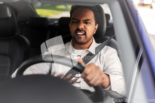 Image of angry indian man or driver driving car