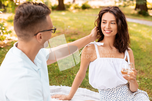Image of happy couple having picnic at summer park
