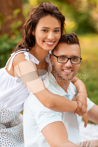 Image of happy couple hugging at summer park