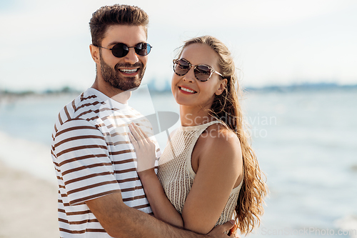 Image of happy couple on summer beach
