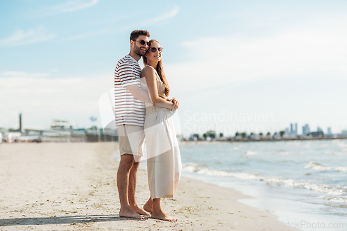 Image of happy couple on summer beach