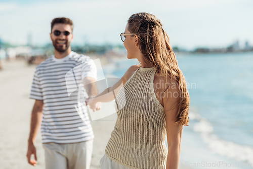 Image of happy couple on summer beach