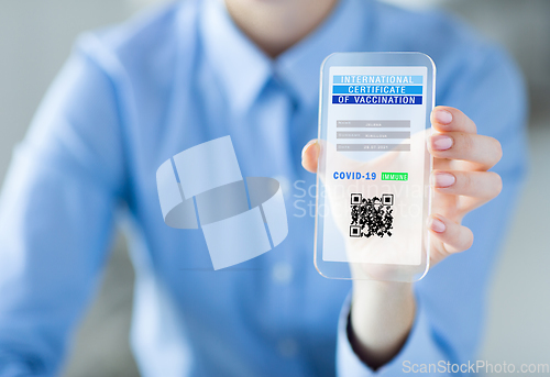 Image of hand with virtual immunity passport on smartphone