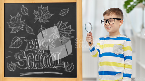 Image of little student boy with magnifying glass