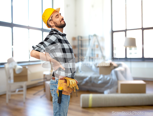 Image of male worker or builder having back ache at home