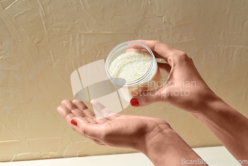Image of hands with bath salt in jar