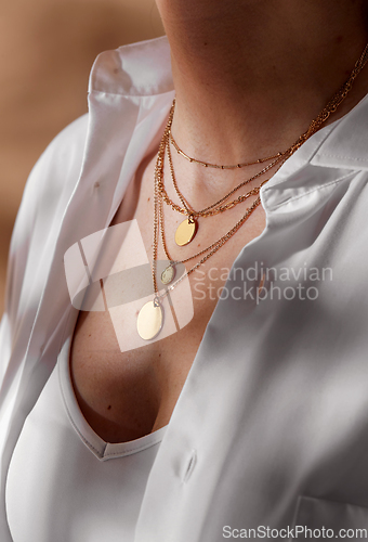 Image of close up of woman with multi layer gold chains