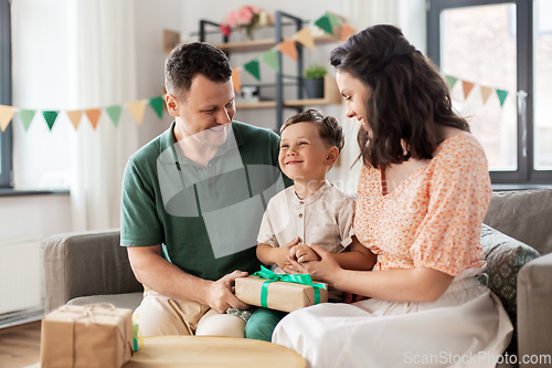 Image of parents giving birthday present to little son