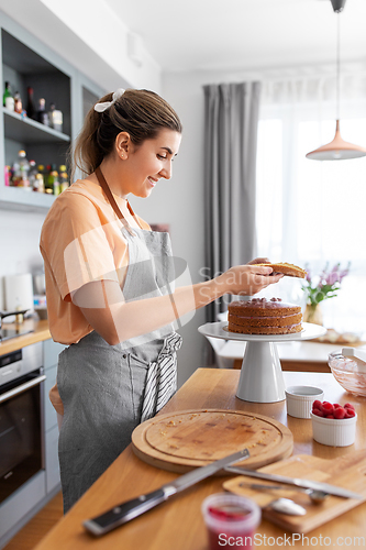 Image of woman cooking food and baking on kitchen at home