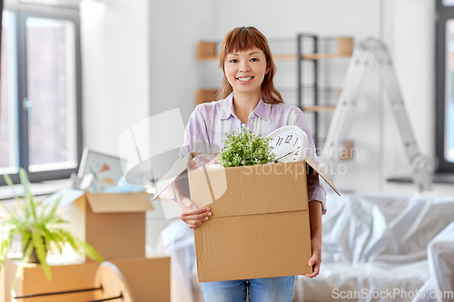 Image of happy woman unpacking boxes and moving to new home