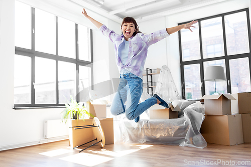 Image of happy asian woman with stuff moving to new home