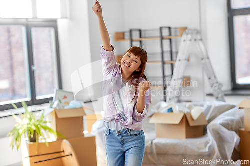 Image of happy asian woman with stuff moving to new home