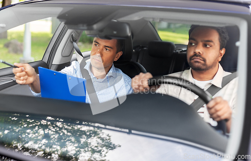 Image of car driving school instructor and young driver