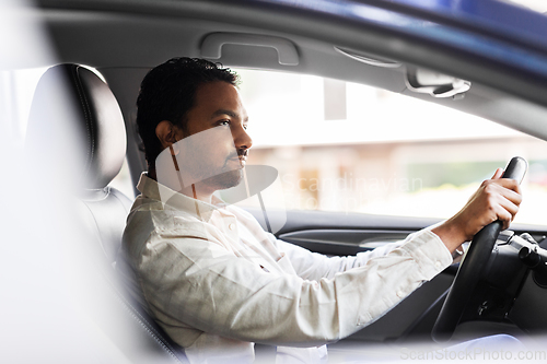 Image of indian man or driver driving car