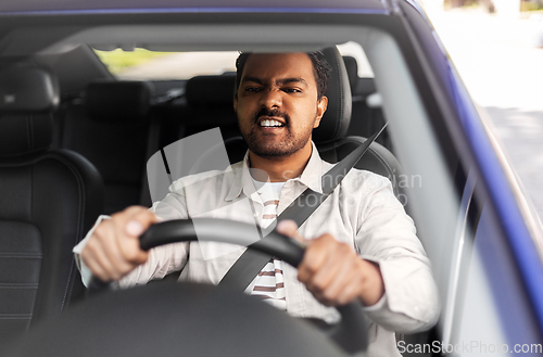 Image of angry indian man or driver driving car