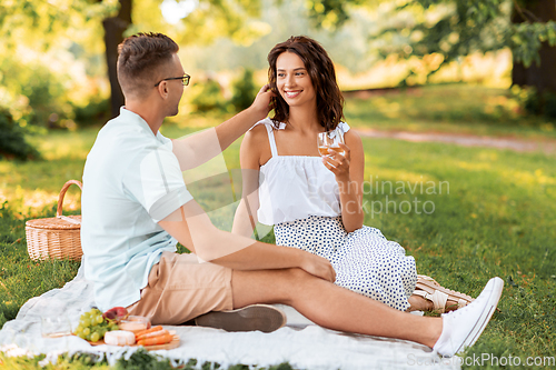 Image of happy couple having picnic at summer park