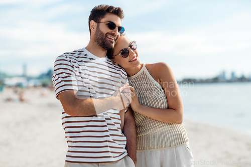 Image of happy couple on summer beach