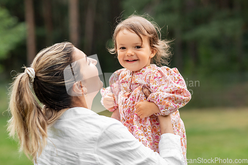 Image of happy smiling mother with baby girl outdoors