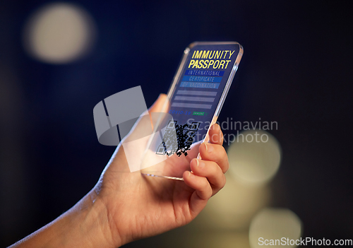 Image of hand holding phone with certificate of vaccination