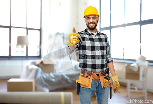 Image of happy male builder showing thumbs up at home