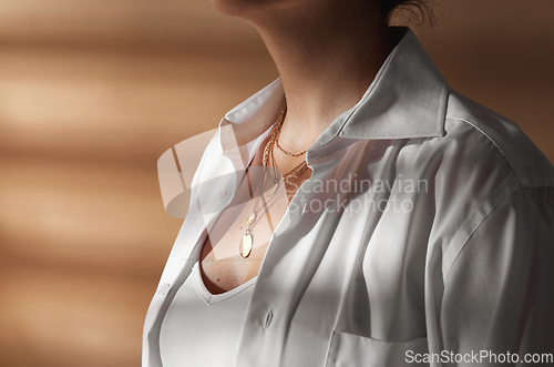 Image of close up of woman with multi layer gold chains