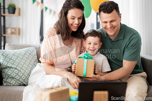 Image of happy family with tablet pc at home on birthday