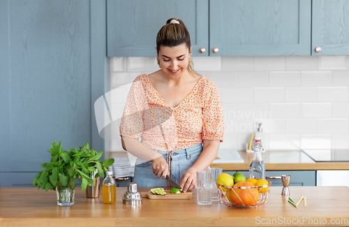 Image of woman making cocktail drinks at home kitchen