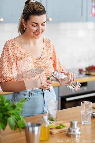 Image of woman making cocktail drinks at home kitchen