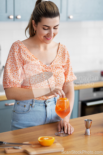 Image of woman making cocktail drinks at home kitchen