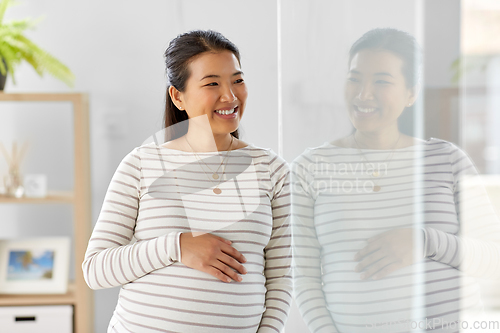 Image of happy pregnant asian woman at home