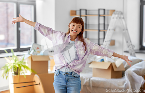 Image of happy asian woman with stuff moving to new home