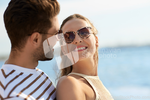 Image of portrait of happy couple on summer beach