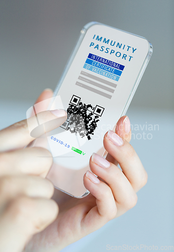 Image of hand holding phone with certificate of vaccination